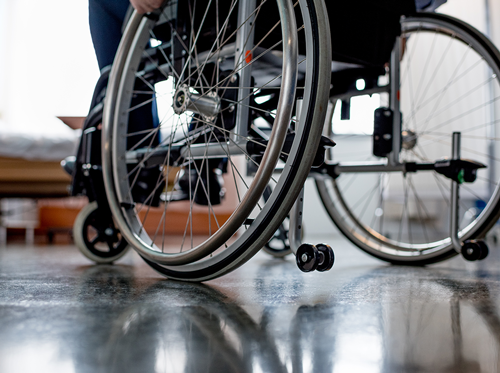 Rear, lower half view of patient in a wheelchair.