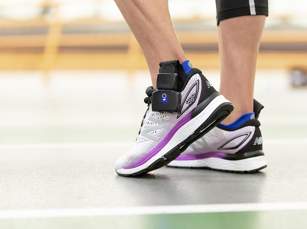 Athlete wearing running shoes with XSENSOR's Intelligent Insoles inside.