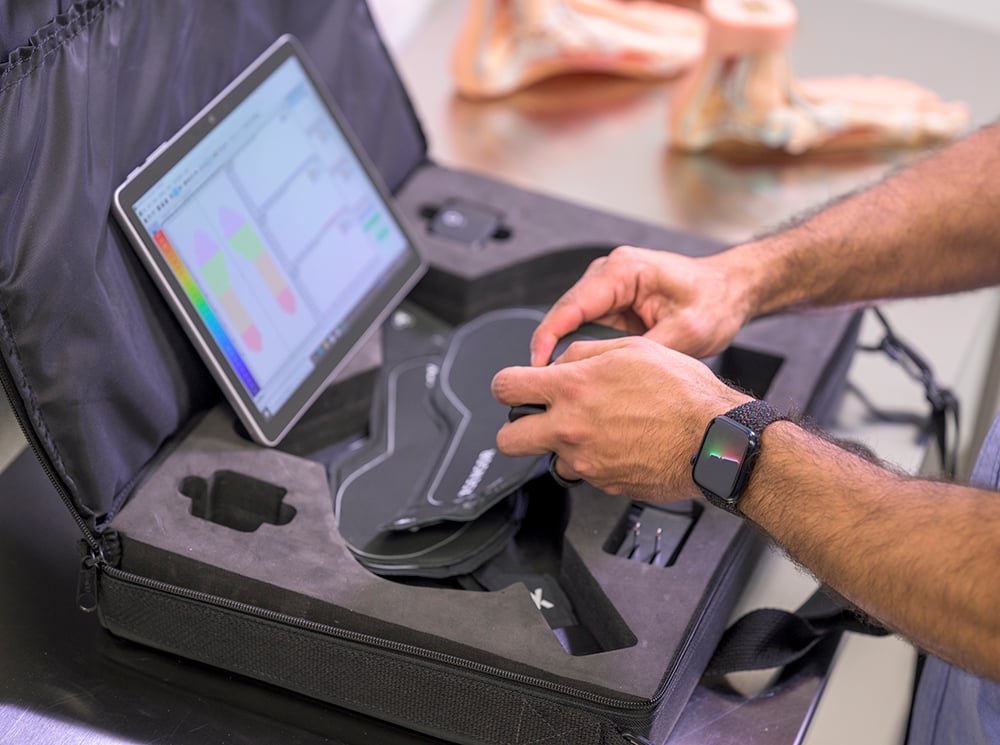 A coach installing XSENSOR's Intelligent Insoles | Pro toolkit. A coach installing XSENSOR's Intelligent Insoles | Pro toolkit.