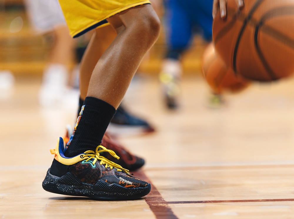 Lower legs of a basketball player.