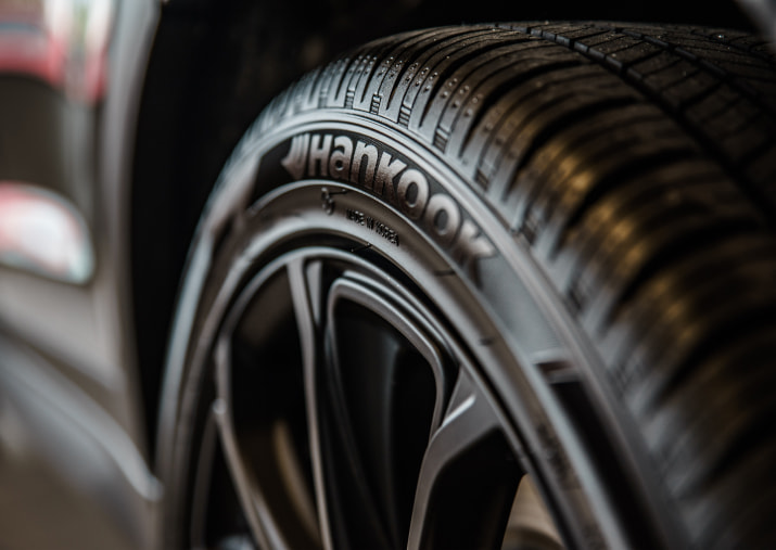 Tire on a rim installed on a vehicle.