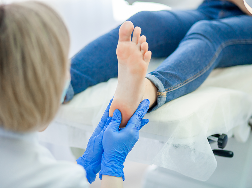 Clinician inspecting patient's foot.