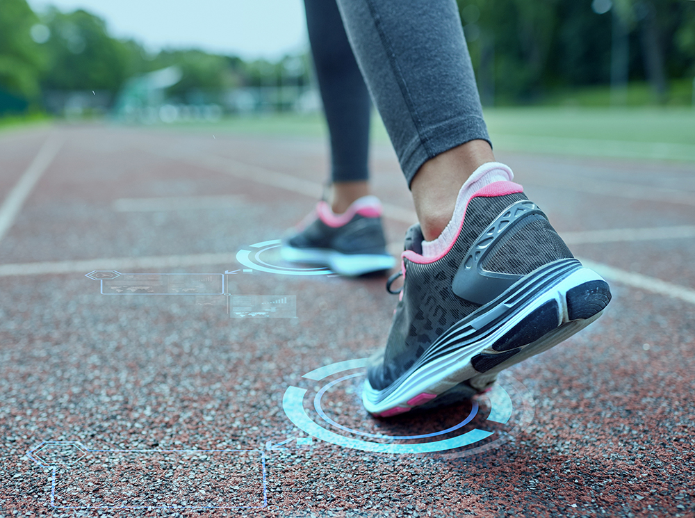 Running shoes walking down a running track.